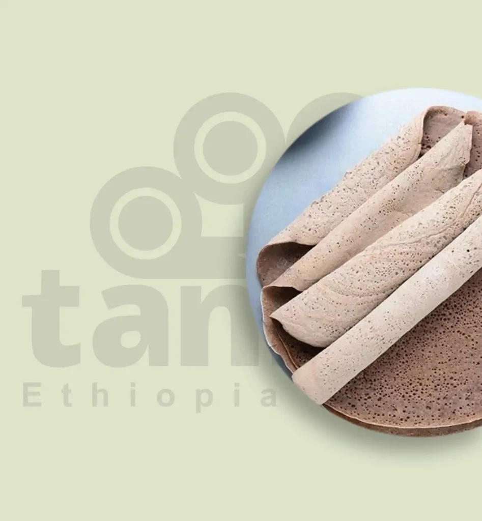 A traditional Ethiopian injera flatbread, crafted from fermented teff flour, showcasing its iconic spongy texture and lacy, porous surface. This staple of Ethiopian cuisine boasts a tangy flavor, perfect for pairing with vibrant stews and dishes.