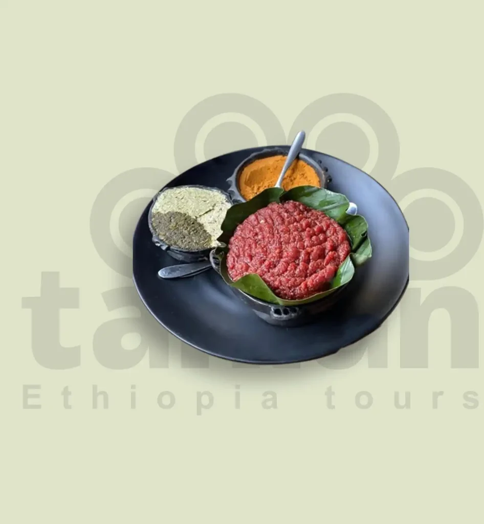 Kitfo, a traditional Ethiopian dish, is made from finely chopped raw beef marinated in a spicy butter mixture. It's often served with green cabbage, cottage cheese, and injera. While it may seem unusual to Westerners, kitfo is a beloved delicacy among Ethiopians.