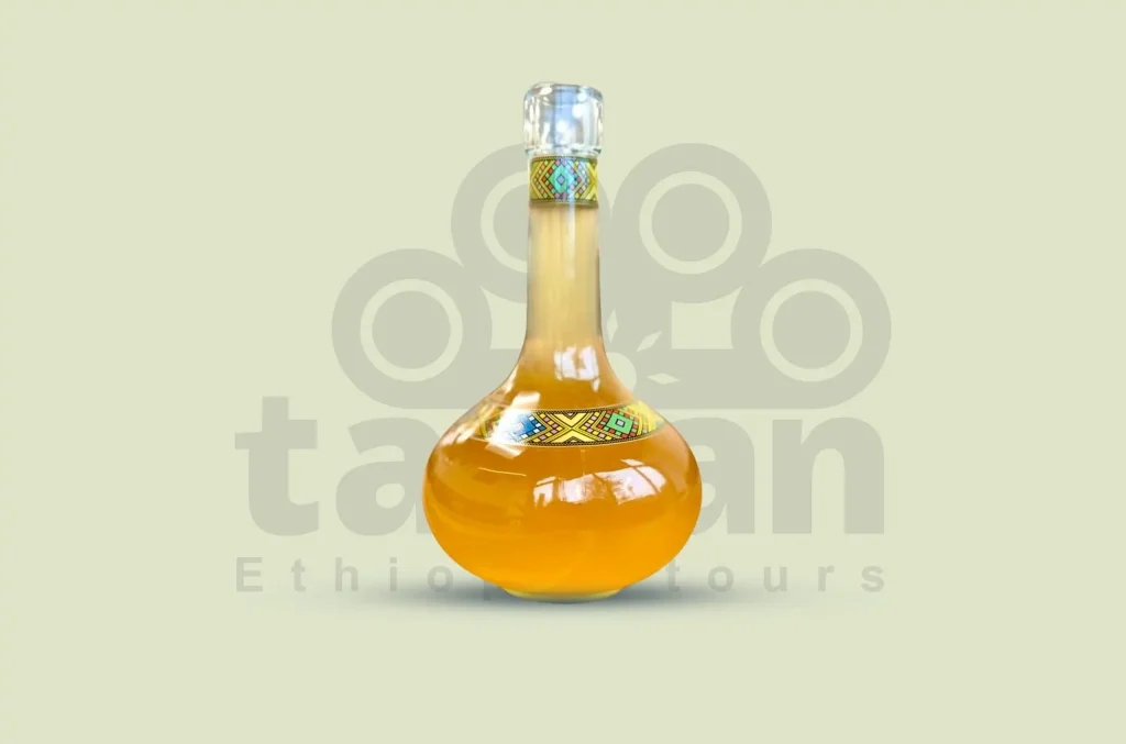 Ethiopia's national honey wine, a sweet and slightly bitter alcoholic drink made from honey, water, yeast, and gesho leaves.