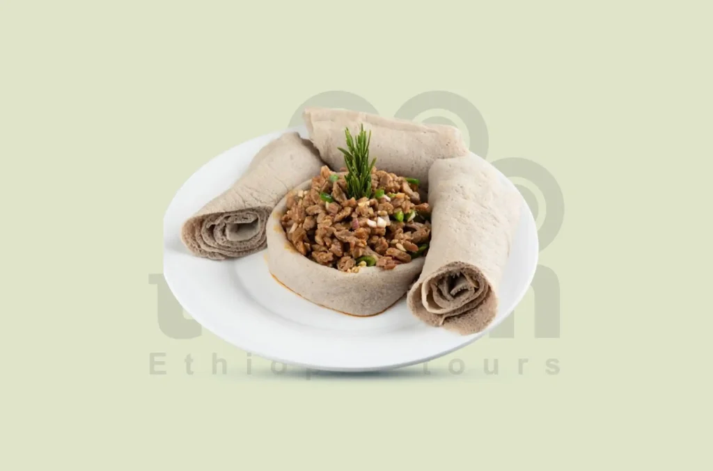 Tibs is a sizzling dish made from sautéed meat (beef, goat, or lamb) with onions, garlic, and rosemary. It's often served with injera and a spicy awaze sauce.