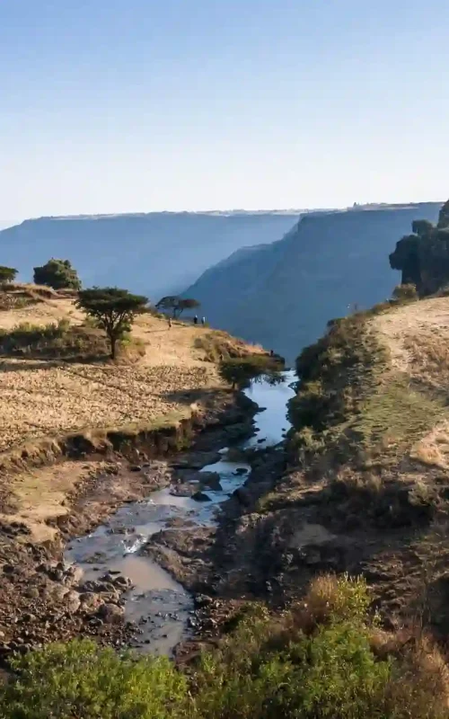 Top-down perspective of a waterfall and its plunge pool in the rugged, dramatic landscape of the Blue Nile Gorge.