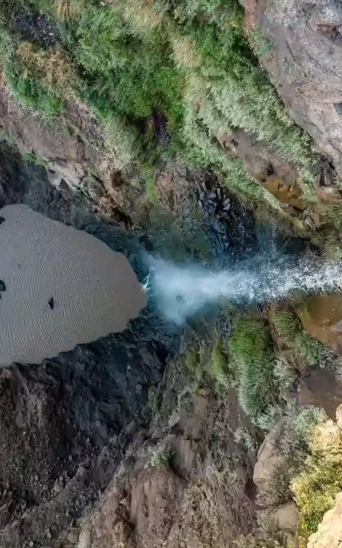 Top-down perspective of a waterfall and its plunge pool in the rugged, dramatic landscape of the Blue Nile Gorge.
